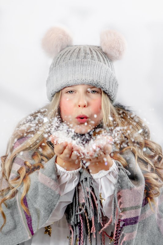 Kyla blowing Snow Christmas Mini Session - Emma Lowe Photography in Rugby