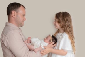 Dad with his 2 daughters in a lovely posed shot during newborn shoot