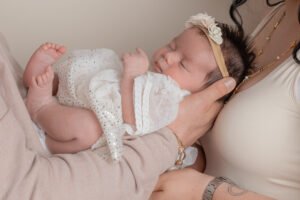 Emma Lowe Photography Newborn Photographer Close up being held my parents
