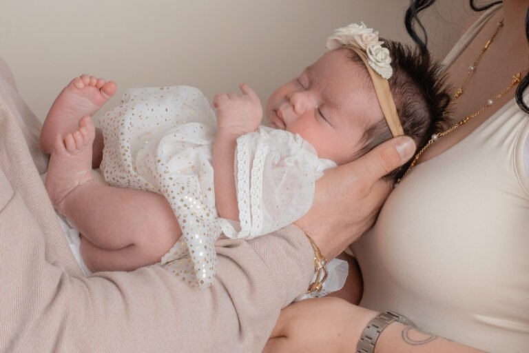 Emma Lowe Photography Newborn Photographer Close up being held my parents