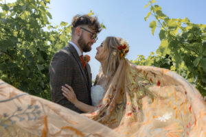 Bride & Groom newly married, looking into each others eyes, with autumnal bridal veil. By Emma Lowe