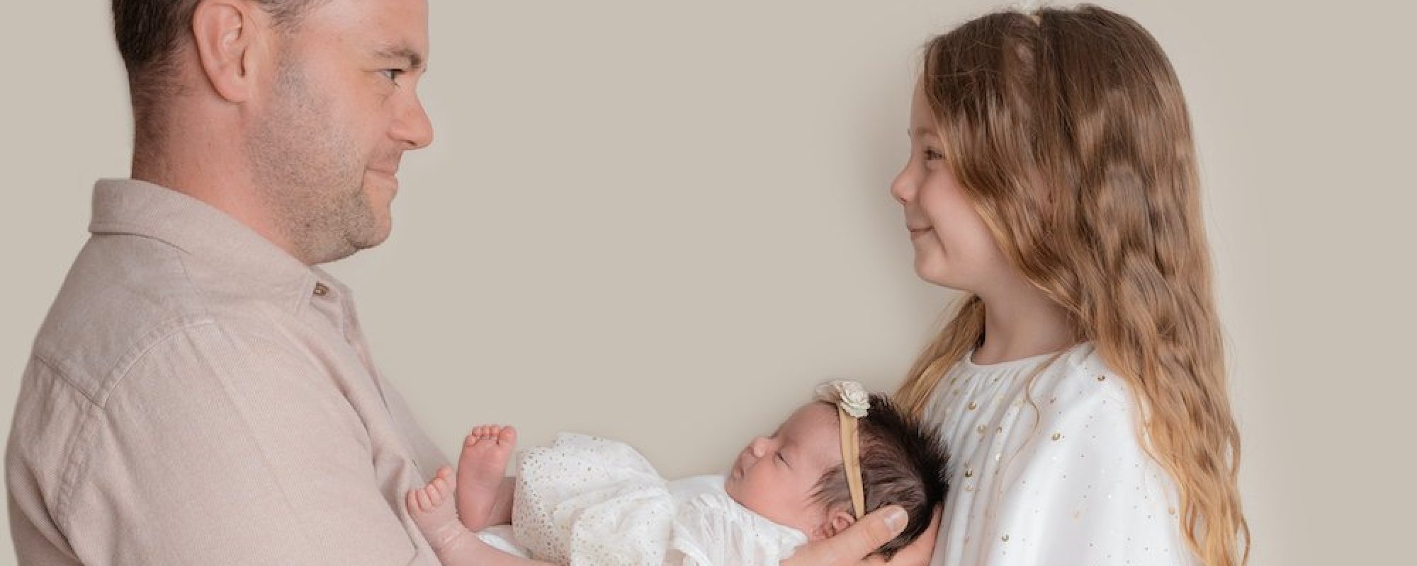 Dad with his 2 daughters in a lovely posed shot during newborn shoot