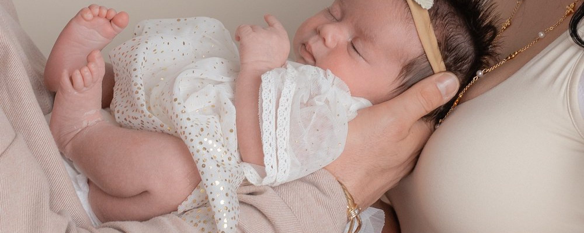 Emma Lowe Photography Newborn Photographer Close up being held my parents